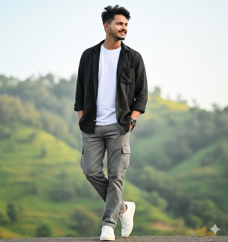Man standing outdoors with greenery in the background