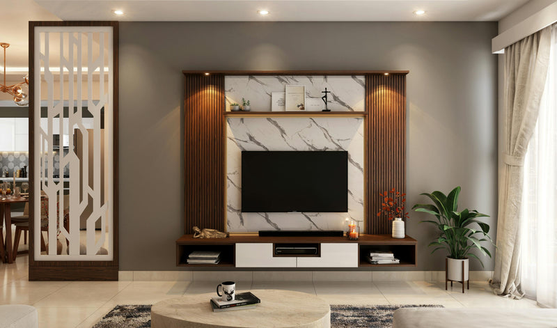Modern living room with a television unit, decorative elements, and a plant.